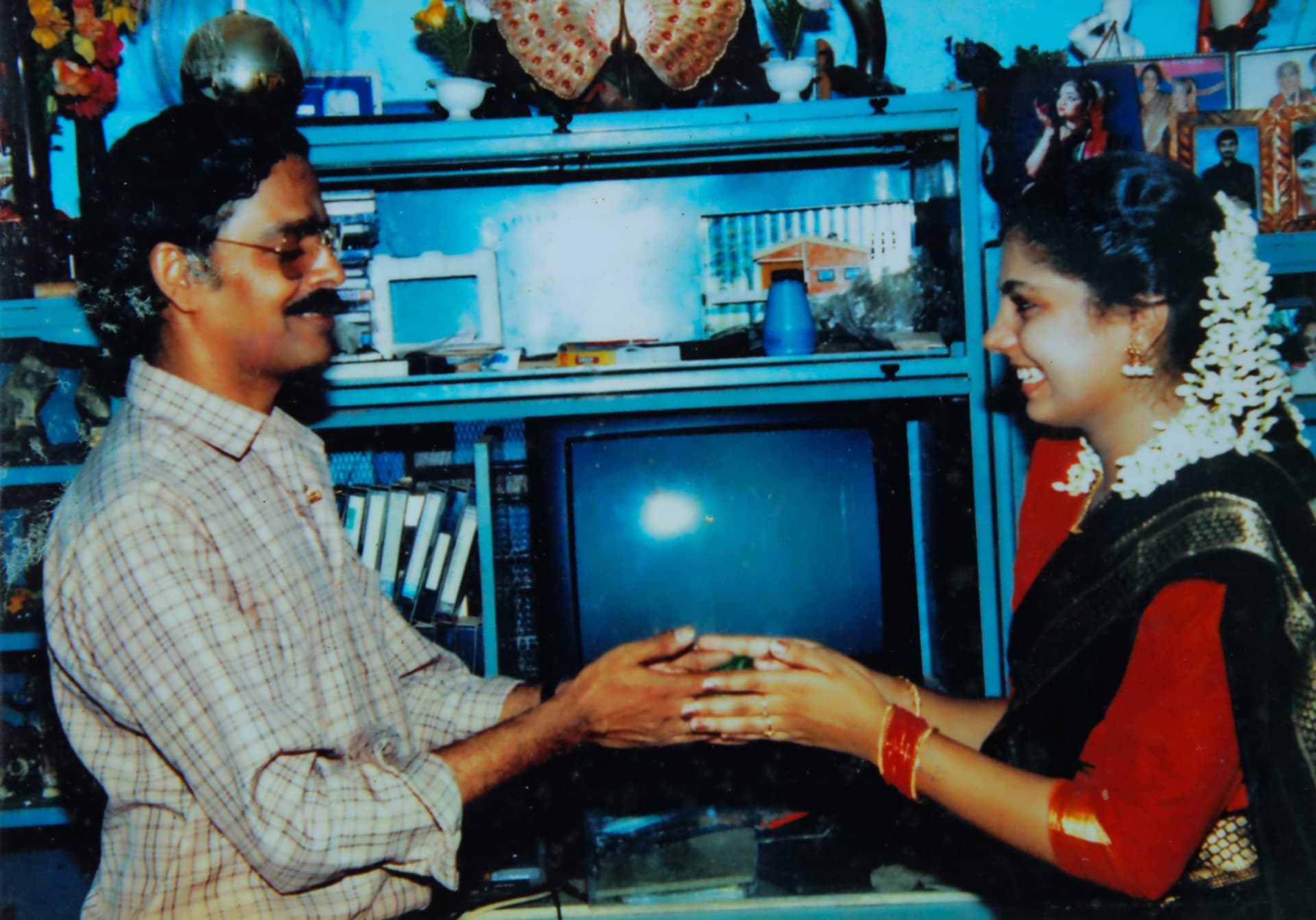 Sri V. S. Janardhanan blessing Asha Sharath wearing jasmine flowers