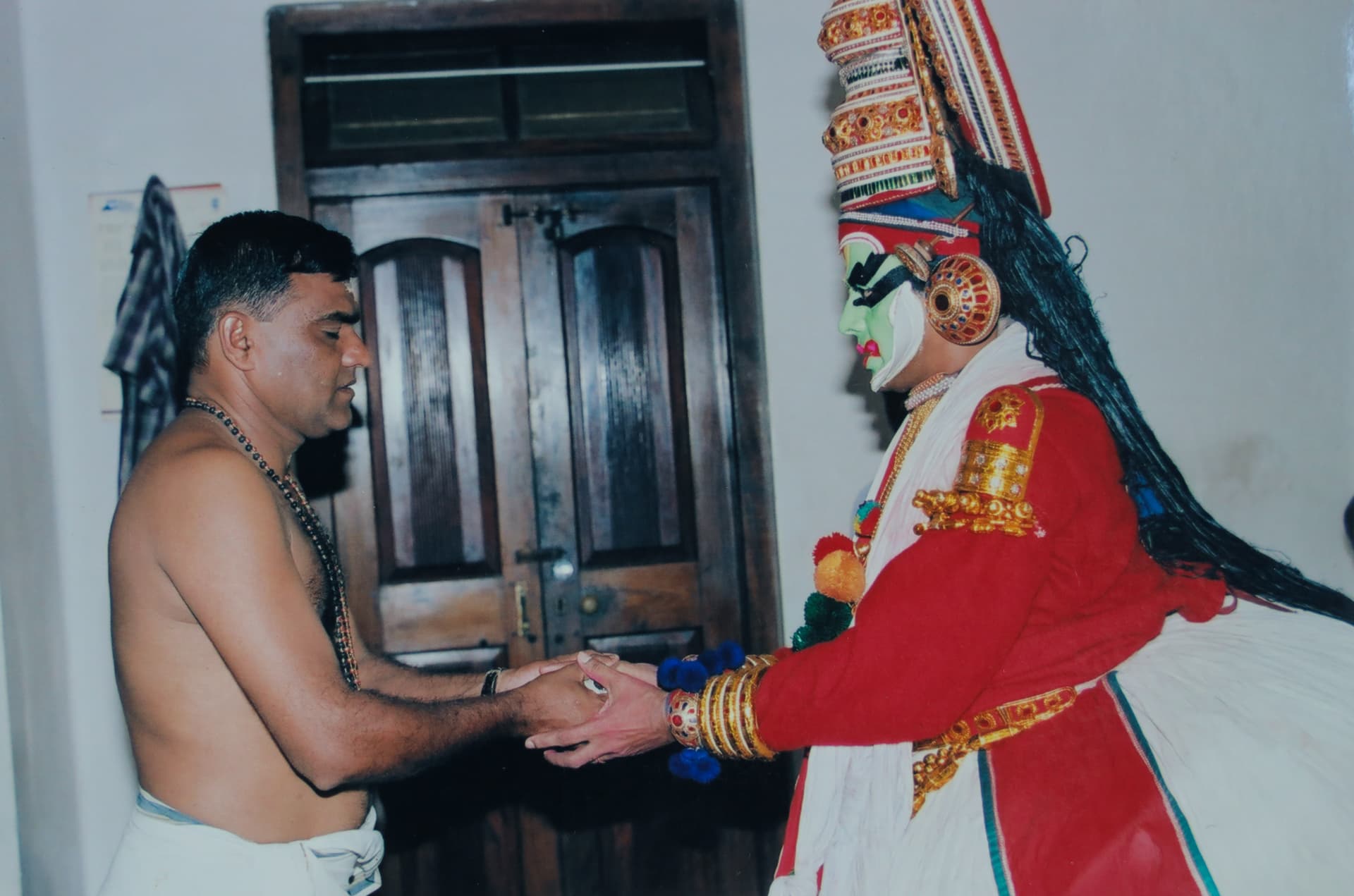 Sri V. S. Janardhanan greeting a Kathakali artist in full costume